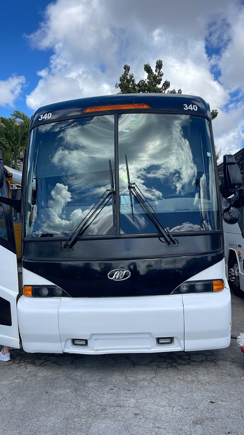 Front view of the white and black coach bus