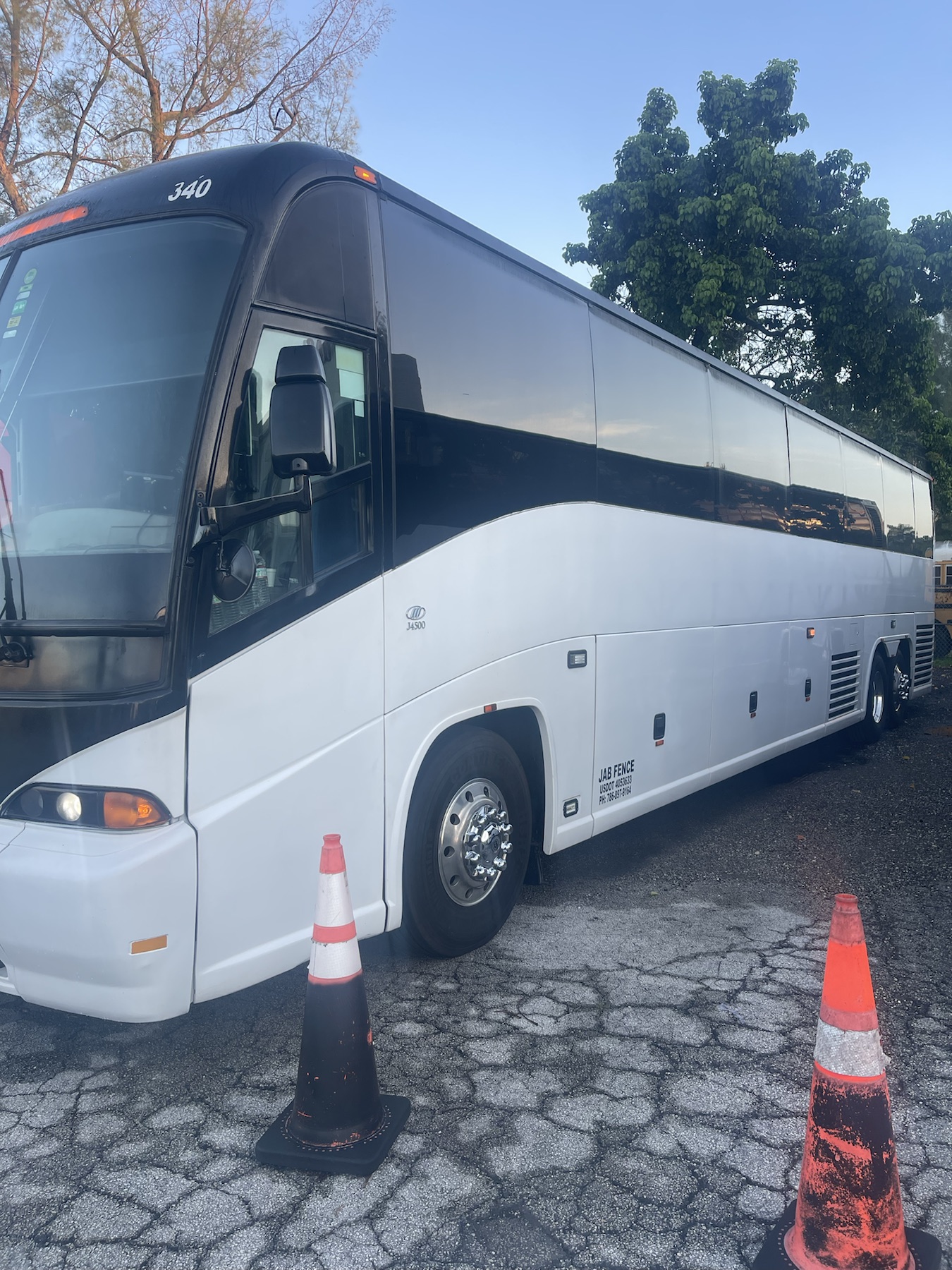 Side profile of the white and black coach bus