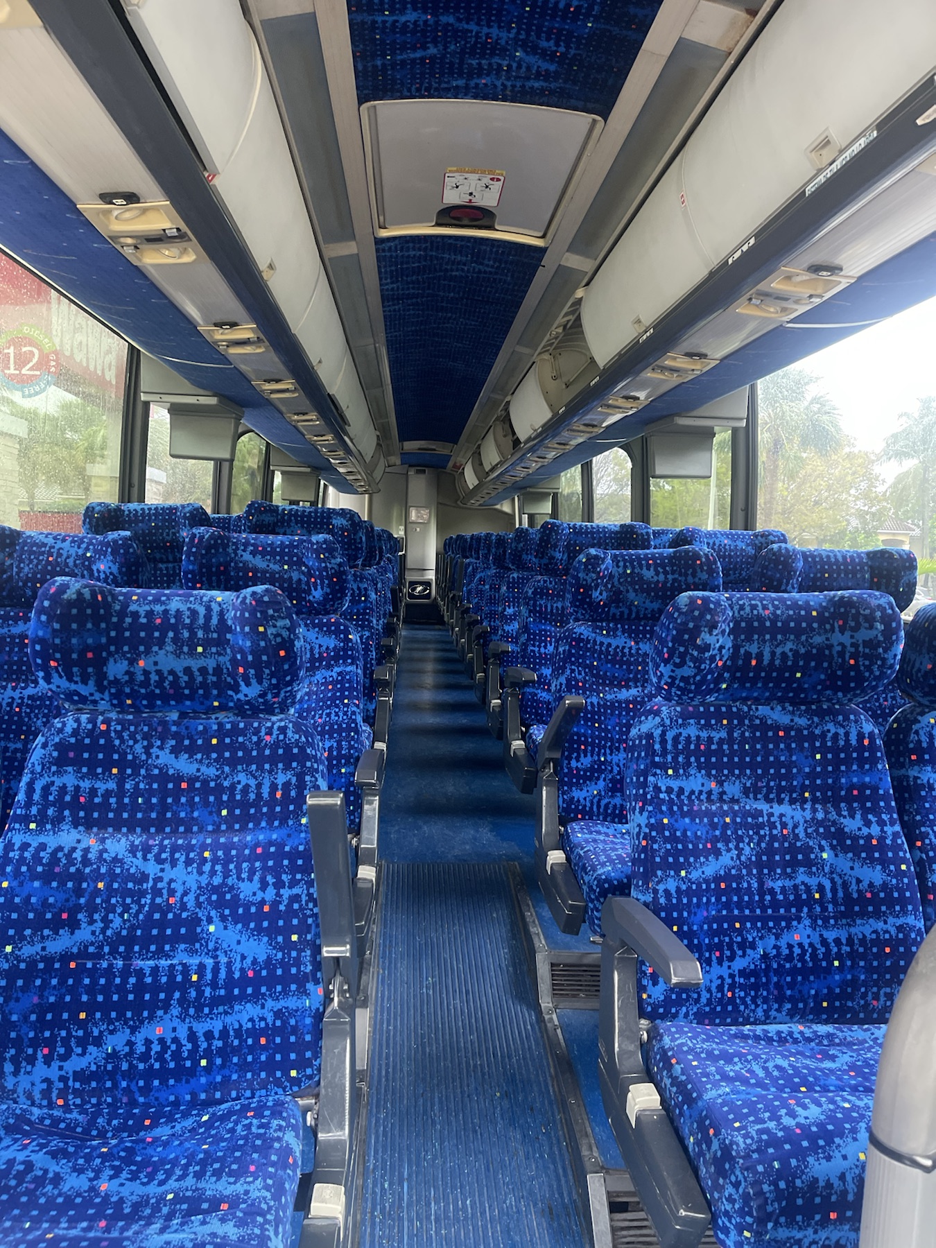 Interior coach bus seating with blue passenger seats